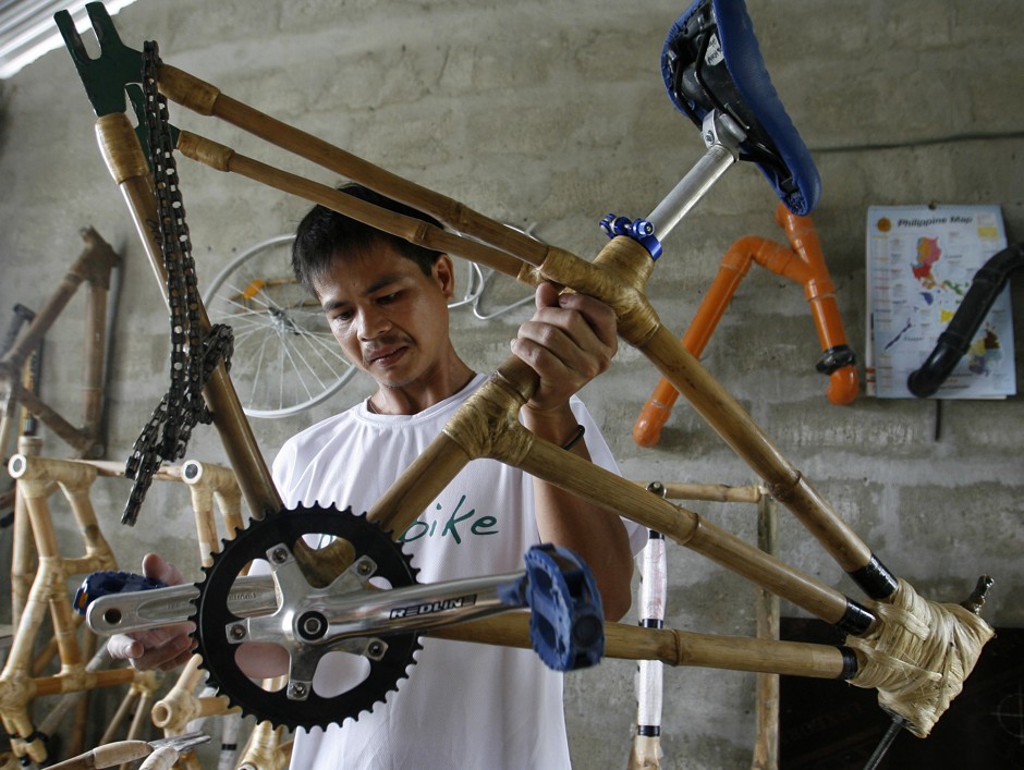 A worker custom builds a bike frame made of bamboo in a small community in Victoria, Tarlac, north of Manila, on January 12, 2011.