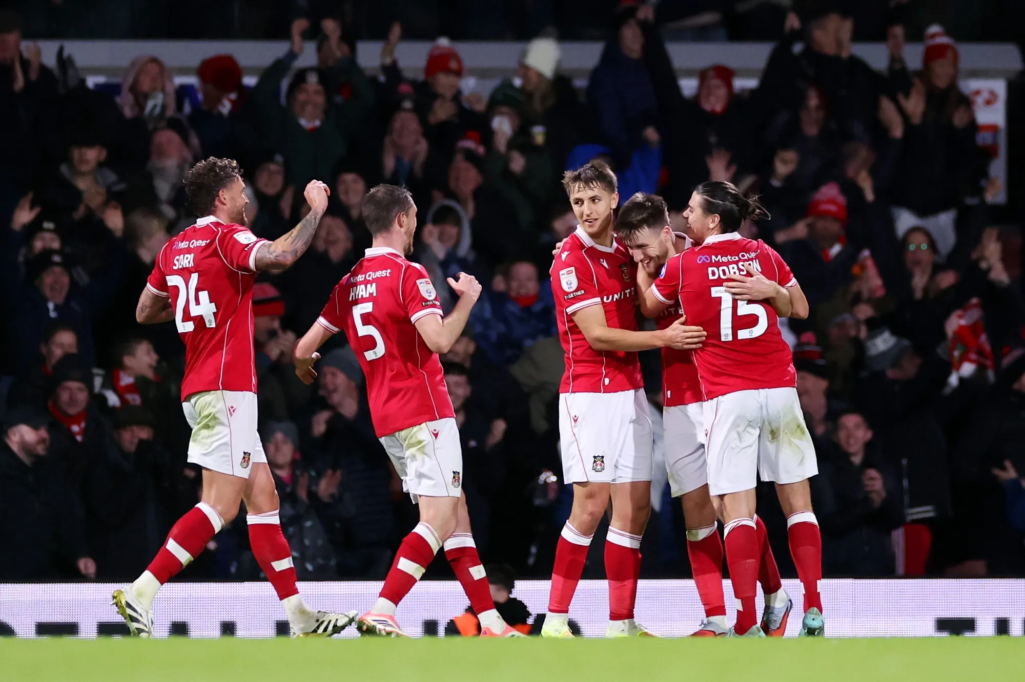 Wrexham players celebrate after a goal during a match against Bristol City at Racecourse Ground in Wrexham, Wales on Nov. 26.