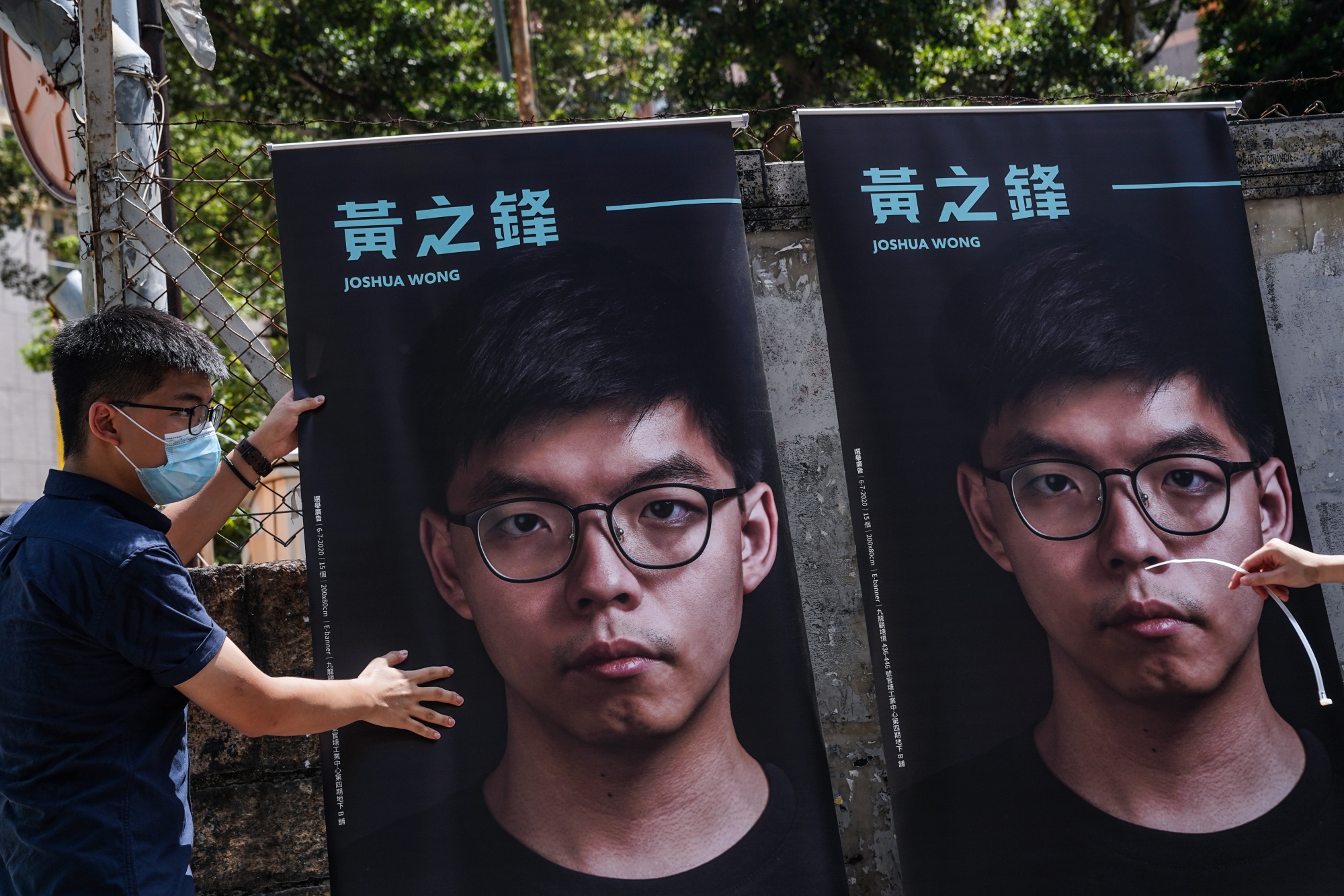 Posters of pro-democracy activist Joshua Wong .
