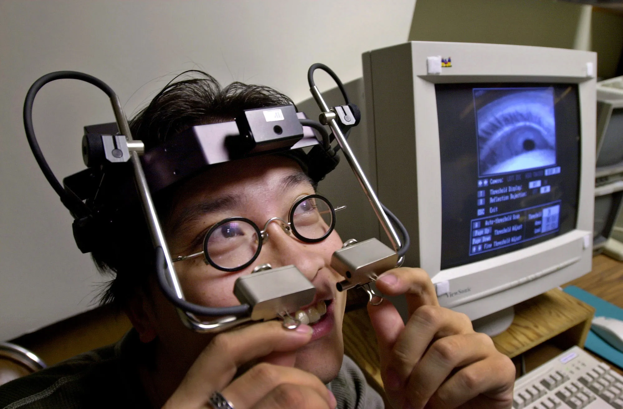 A Xerox PARC computer scientist wears a head-mounted eye-tracking device at the lab in Palo Alto, Calif., in 2001.
