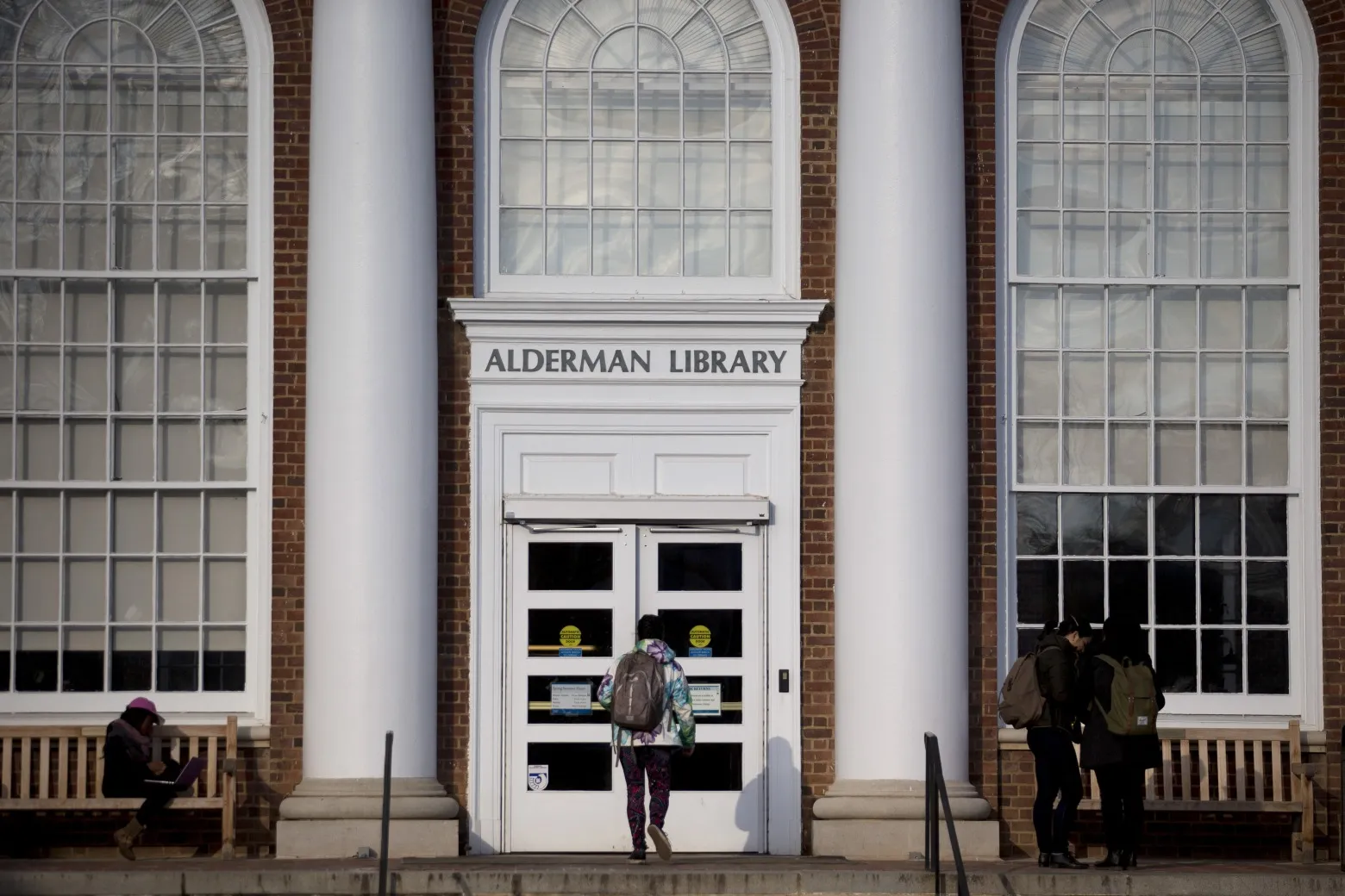A student walks into the Alderman Library on the University of Virginia.