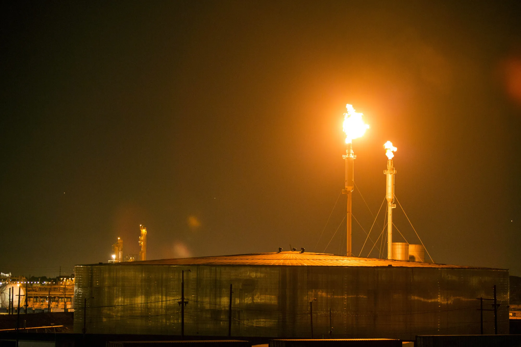 Flames shoot from towers at the Exxon Mobil Torrance Refinery in California. With more big so-called ESG funds investing in companies that sell the fossil fuels whose burning is behind global warming, the investment category is fast losing its purpose.&nbsp;