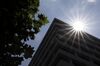 The sun shines down on the Bank of Japan (BOJ) headquarters in Tokyo, Japan, on Tuesday, July 31, 2018. The central bank left its key interest rates unchanged while announcing policy tweaks, including a shift in purchases of exchange-traded funds toward assets linked to the Topix equities index and flexibility in bond operations.