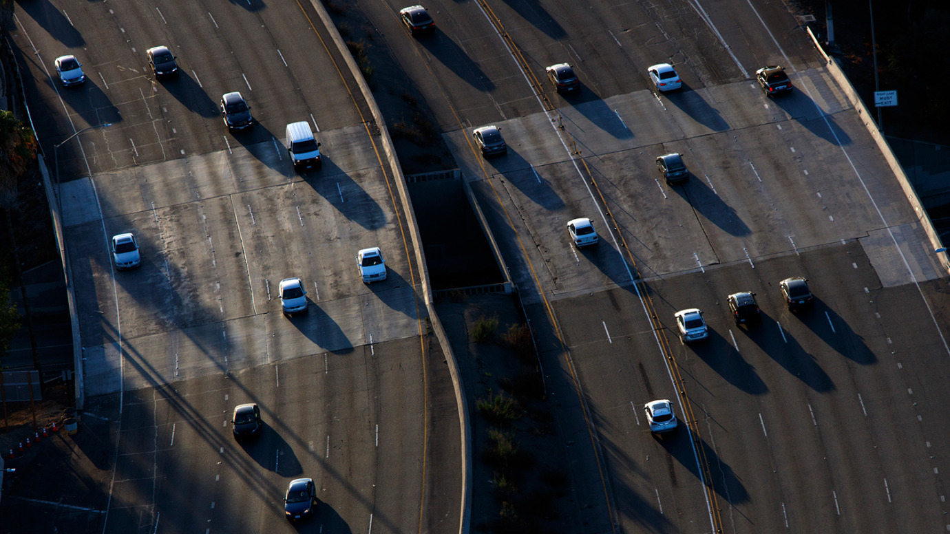 Cars move along during rush hour traffic on the US 101 Freeway in this aerial photograph taken over the Sherman Oaks neighborhood of Los Angeles on July 10, 2015.
