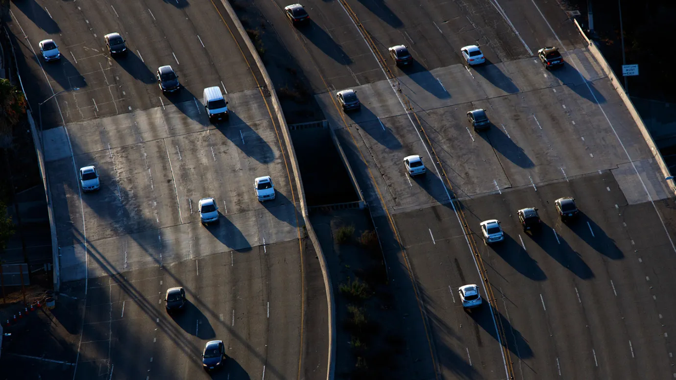Cars move along during rush hour traffic on the US 101 Freeway in this aerial photograph taken over the Sherman Oaks neighborhood of Los Angeles, California, U.S., on Friday, July 10, 2015.
