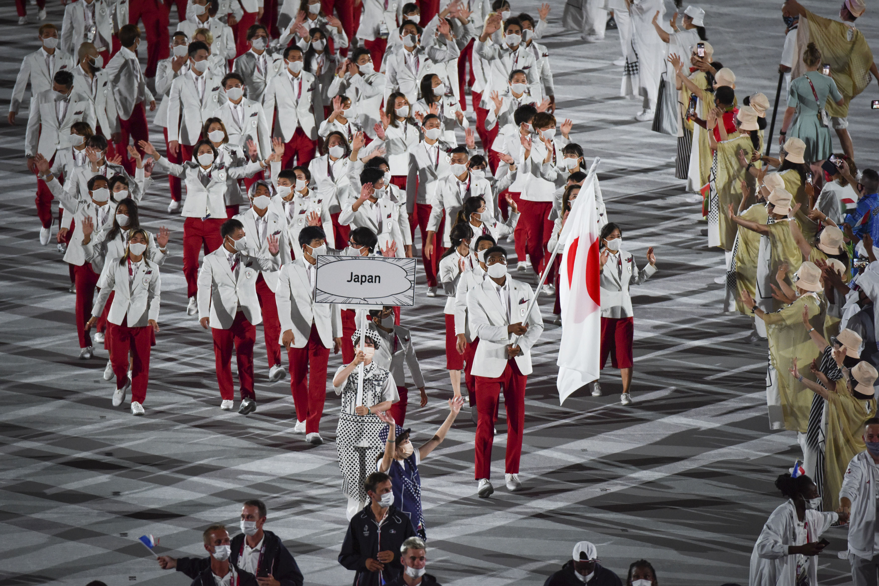 A flag bearer leads the Team Japan delegation during the Olympics opening ceremony.&nbsp;
