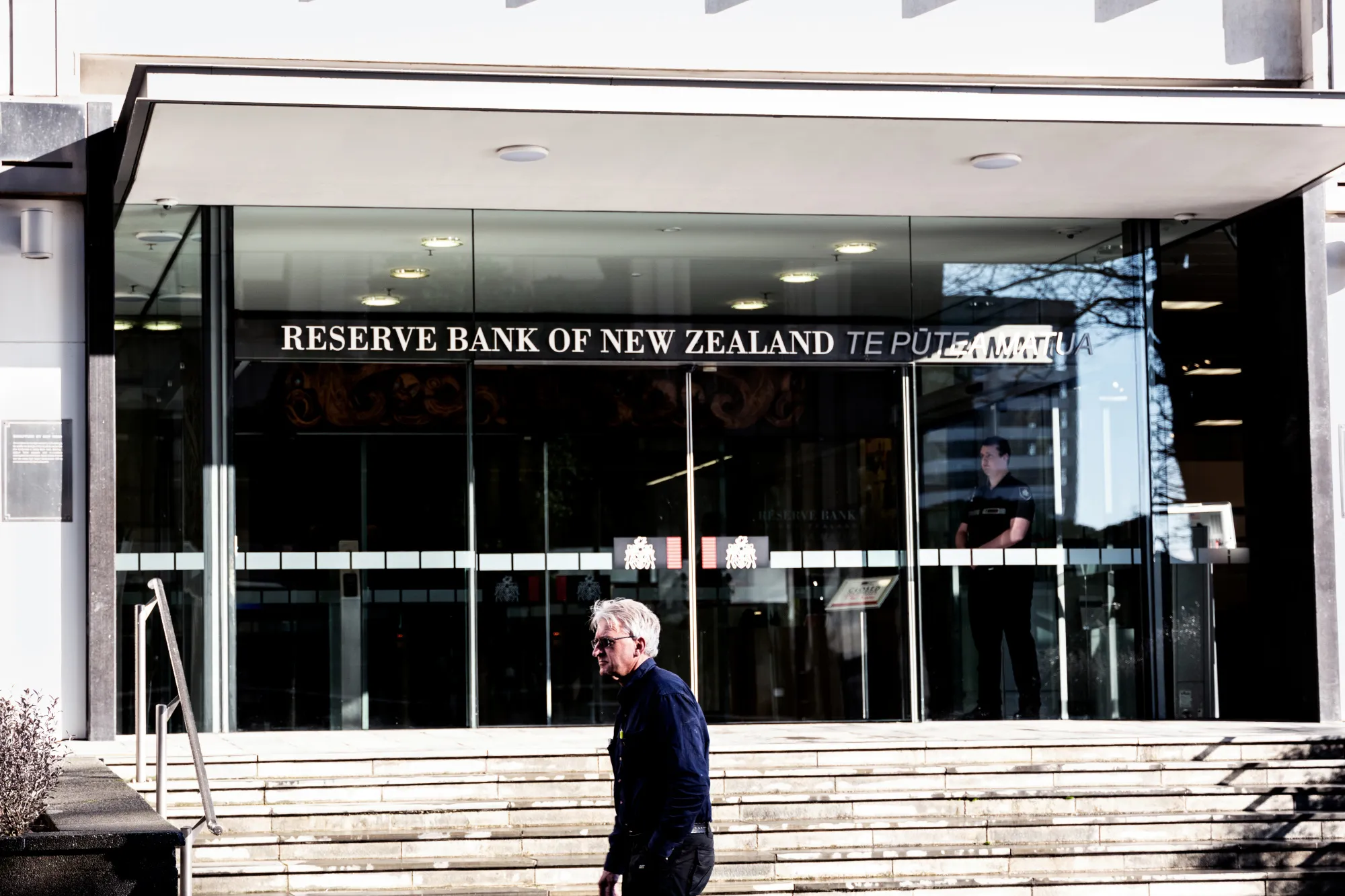 A pedestrians walks past the Reserve Bank of New Zealand in Wellington.