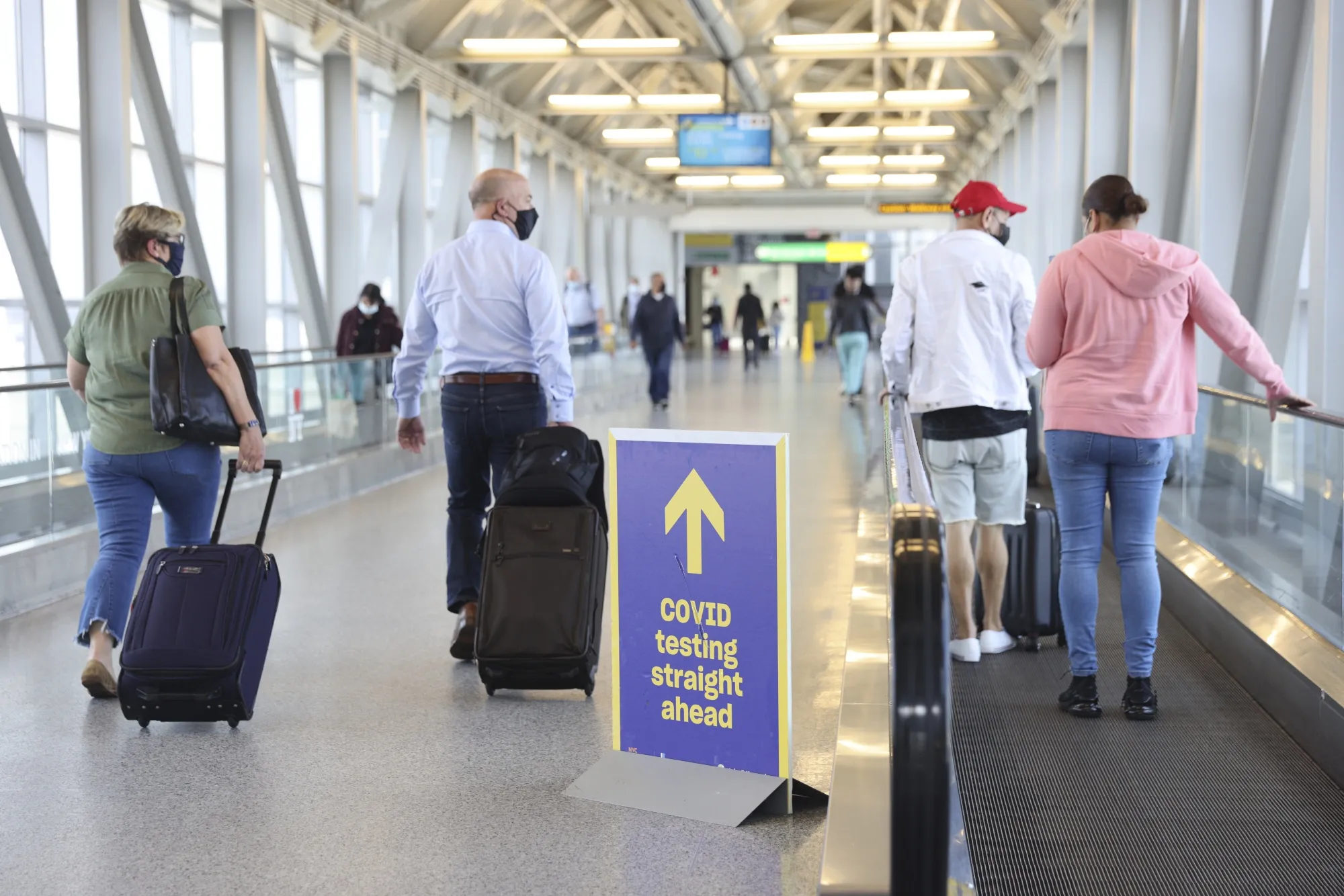 Travelers walk through JFK&nbsp;Airport in New York, on March 26.&nbsp;
