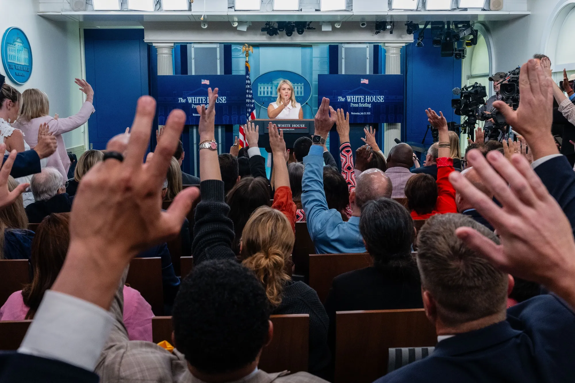 Members of the media raise their hands as Karoline Leavitt, White House press secretary, center, speaks during a news conference in the James S. Brady Press Briefing Room of the White House.