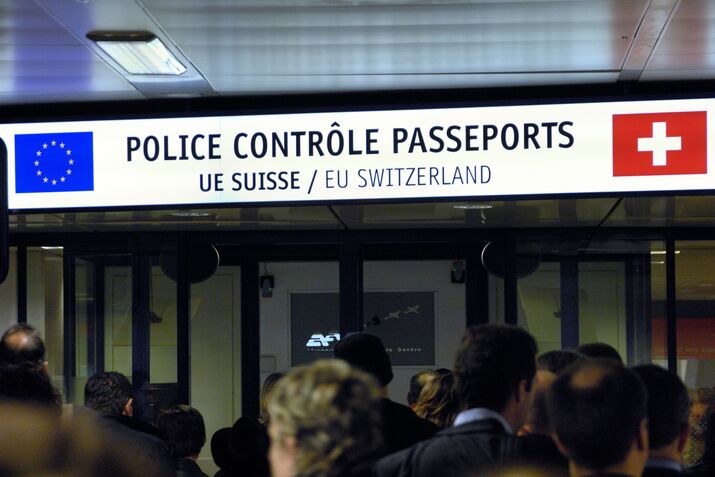 passengers at the EU and Swiss passport control desk in the arrivals-hall