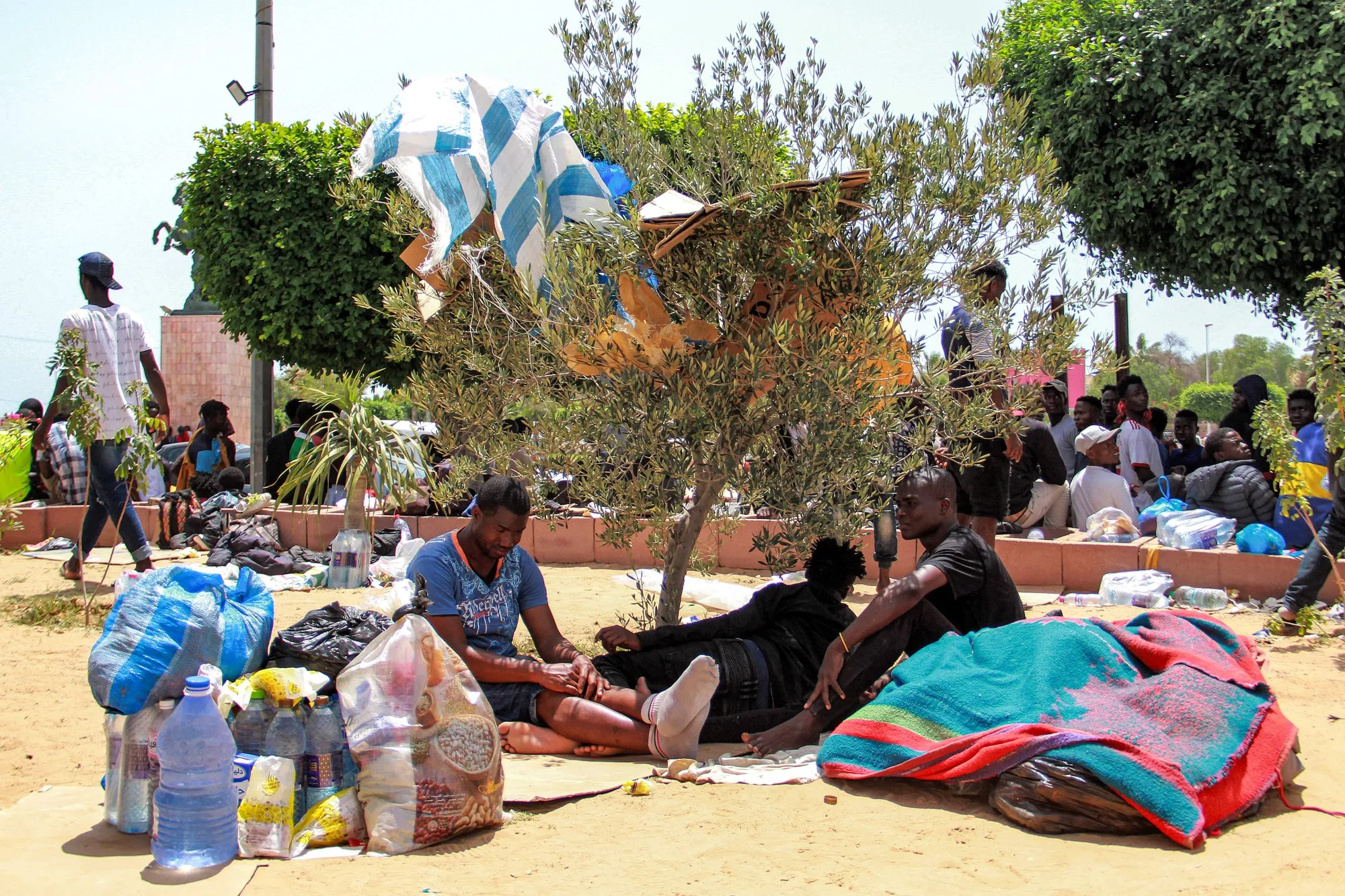 People rest in the shade in Sfax, Tunisia on July 7.