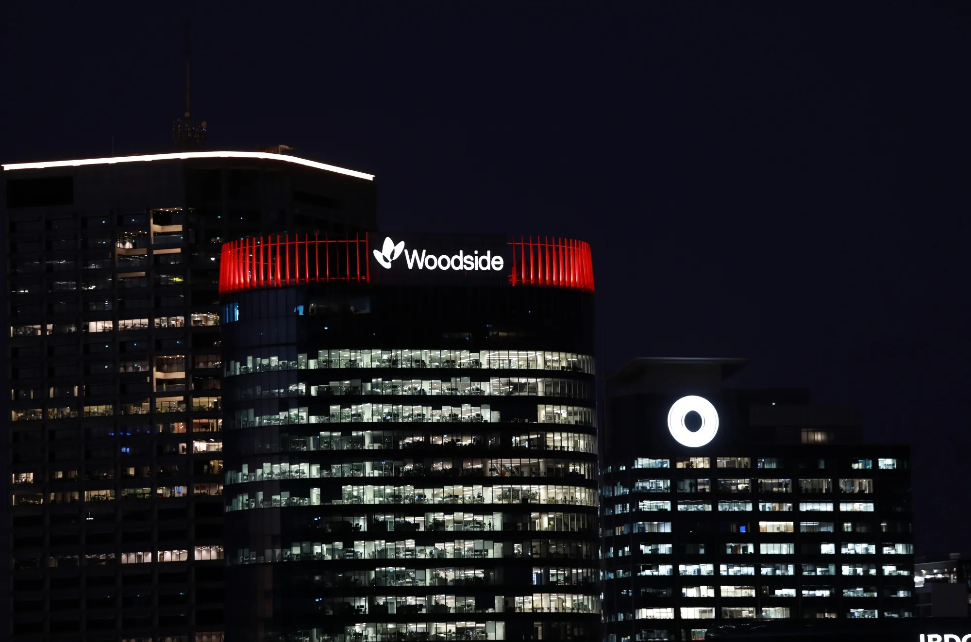 Signage for Woodside Energy Group Ltd. atop the Mia Yellagonga building, which houses the company’s headquarters, center, in Perth,