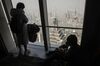 People look at the view from the observation deck at the Shanghai World Financial Center as the Jin Mao Tower, center, and the Oriental Pearl Tower, right, stand in Shanghai, China, on Monday, Feb. 26, 2018. Xi Jinping\'s decision to cast aside China\'s presidential term limits is stoking concern he also intends to shun international rules on trade and finance, even as he champions them on the world stage.