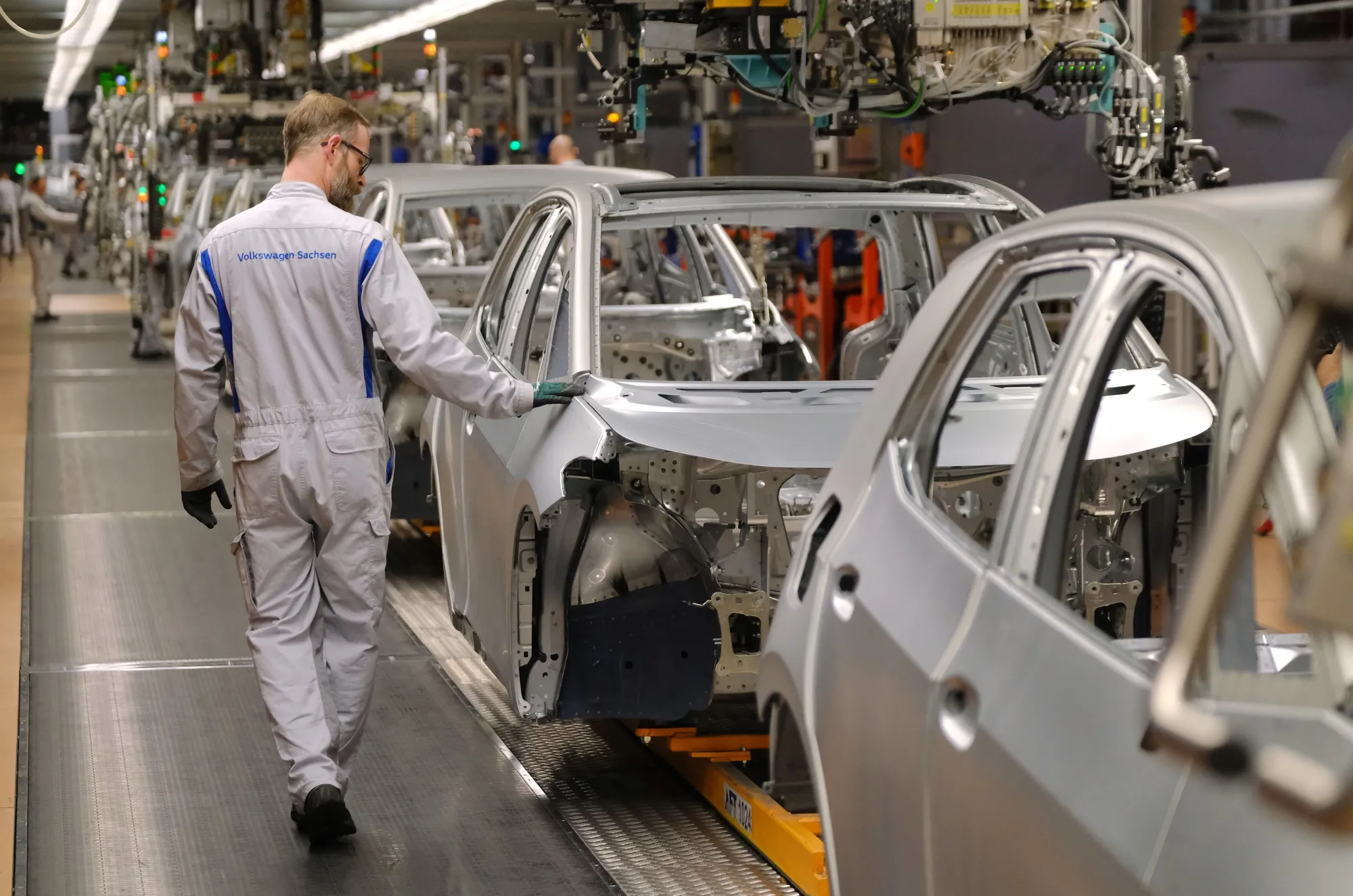 A worker looks over the body a car at the Volkswagen factory in Zwickau, Germany.&nbsp;