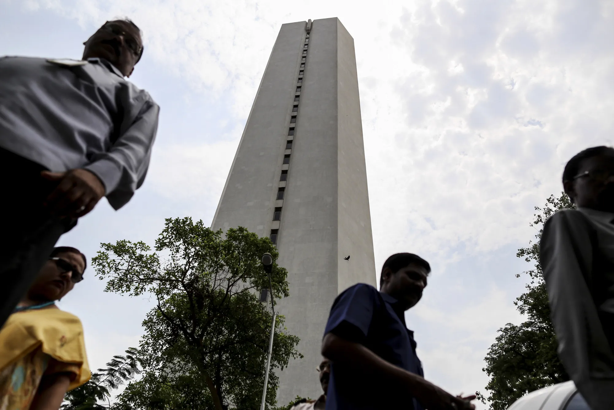 Pedestrians walk past the Reserve Bank of India (RBI) headquarters in Mumbai, India.