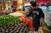 An employee arranges produce for sale at a Whole Foods Market Inc. store in Oakland, California.
