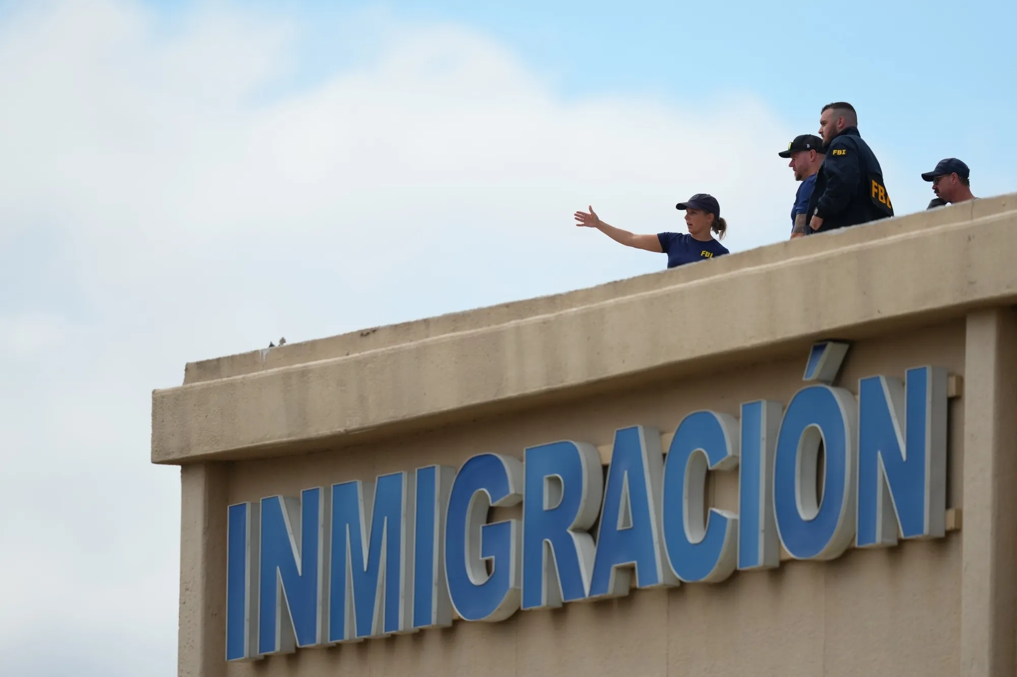 Law enforcement agents investigate on the roof of a building near the scene of a shooting at a US&nbsp;Immigration and Customs Enforcement office in Dallas on&nbsp;Sept. 24, 2025.