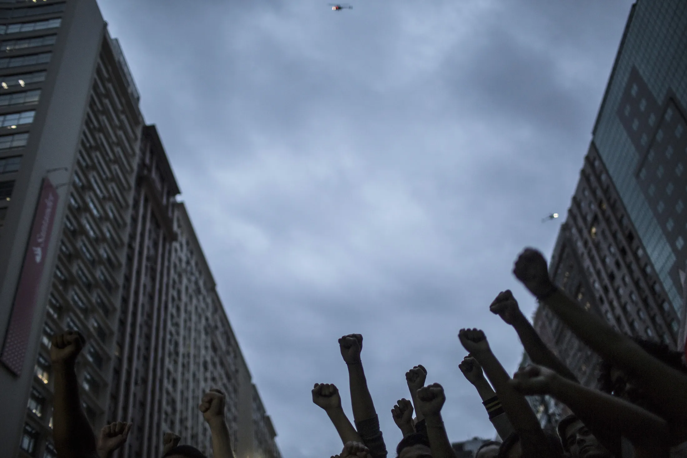 Demonstrators raise their fists in the air during a protest in Rio de Janeiro.
