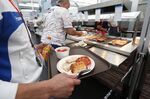 A Japanese athlete waits to be served in the main dining hall during the 2012 Games in London.