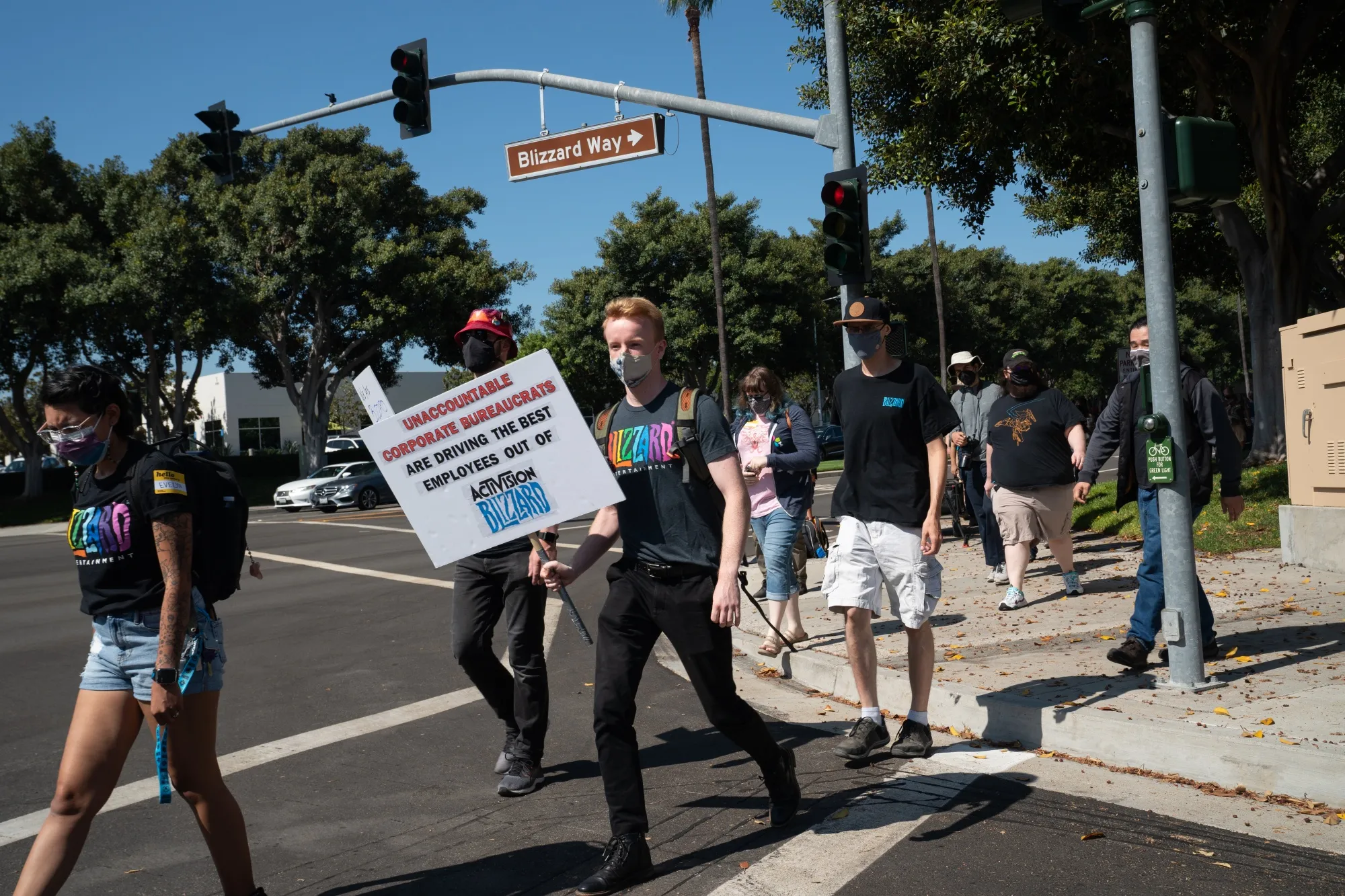 Employees walk across Blizzard Way during a walkout at Activision Blizzard offices in Irvine, California on July 28,.