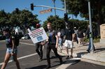 Employees walk across Blizzard Way during a walkout at Activision Blizzard offices in Irvine, California on July 28,.