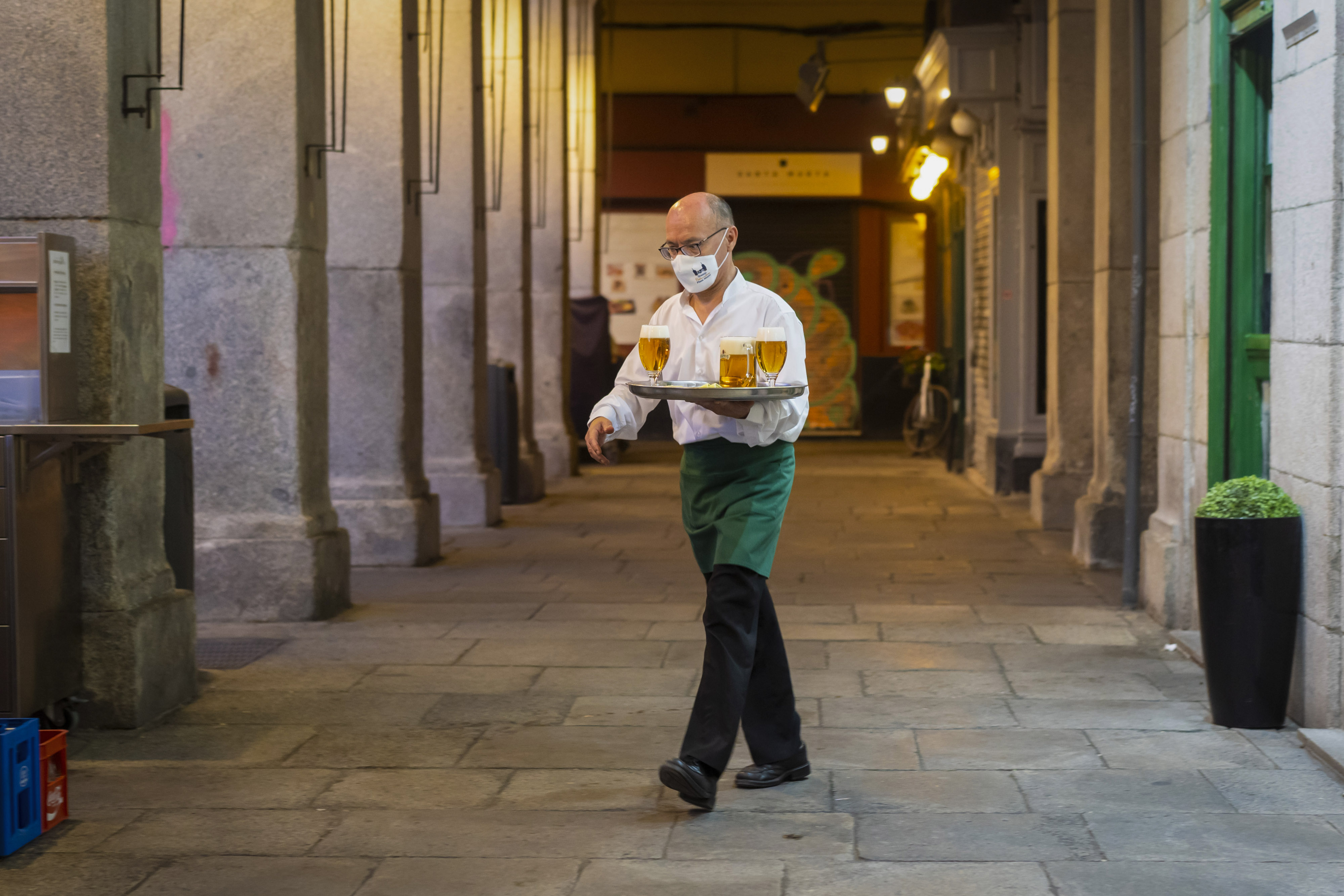 A waiter serves customers at an outside restaurant terrace in Plaza Mayor square, Madrid, Spain, on Wednesday, July 28, 2021. Spain is on track to be one of the fastest-growing economies among developed countries as the post-pandemic recovery accelerates, according to Prime Minister Pedro Sanchez.