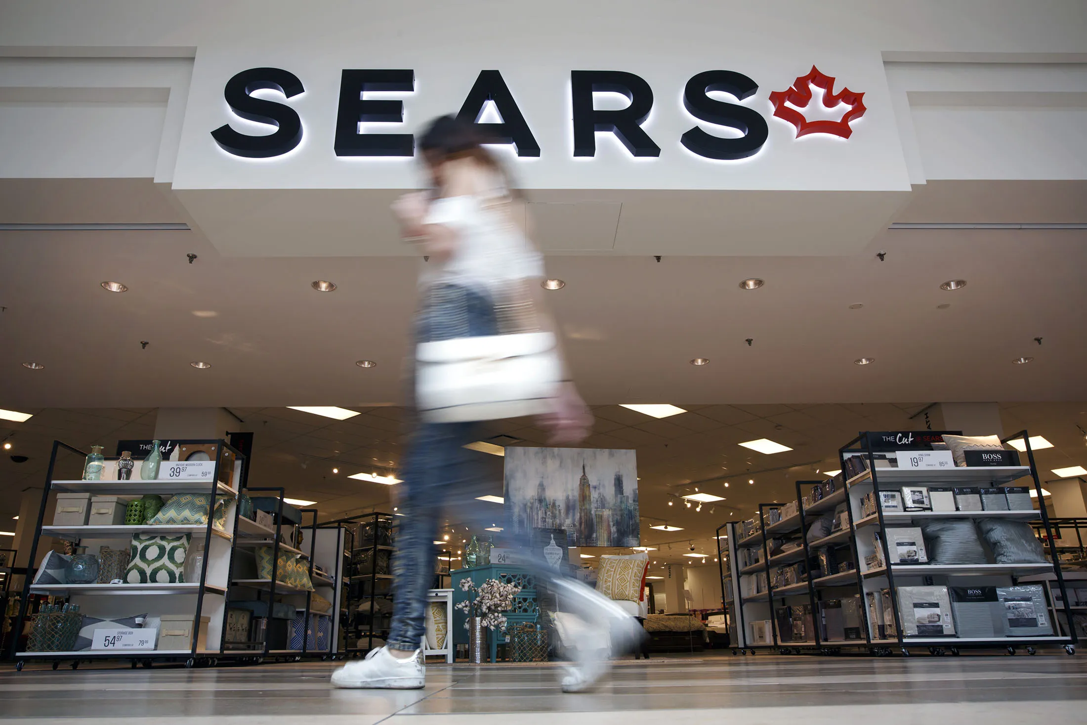 A shopper walks past a Sears Canada Inc. store inside a mall in Toronto, Ontario, Canada, on June 22, 2017.
