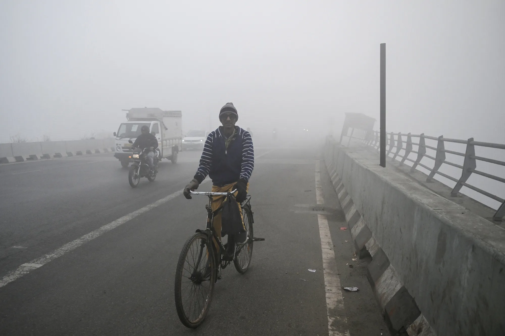 Commuters amid dense smog in New Delhi on Dec. 27.