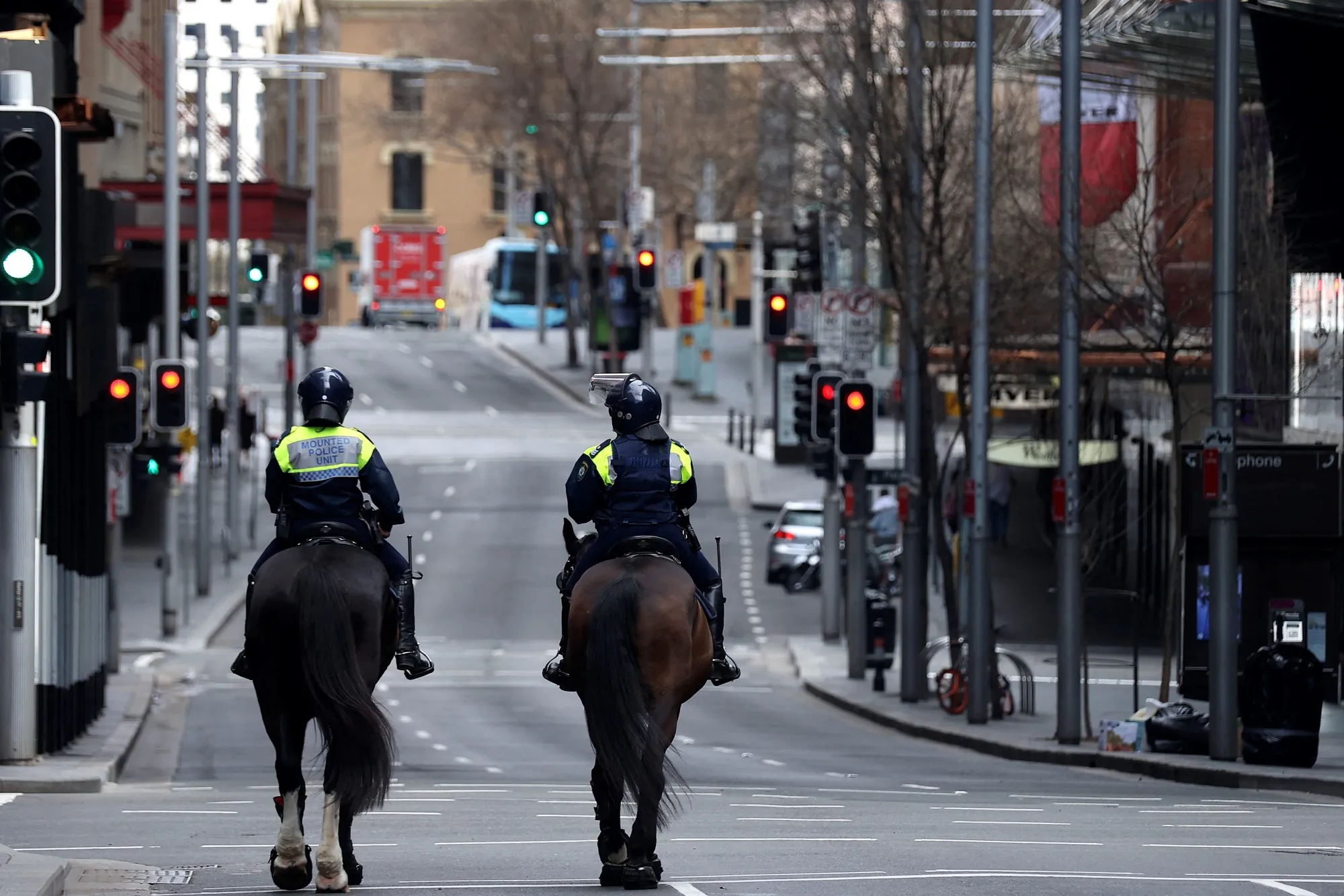 Police officers patrol the empty central business district of Sydney on July 3.