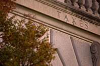 The word "Taxes" is seen on the facade of the Internal Revenue Service (IRS) headquarters