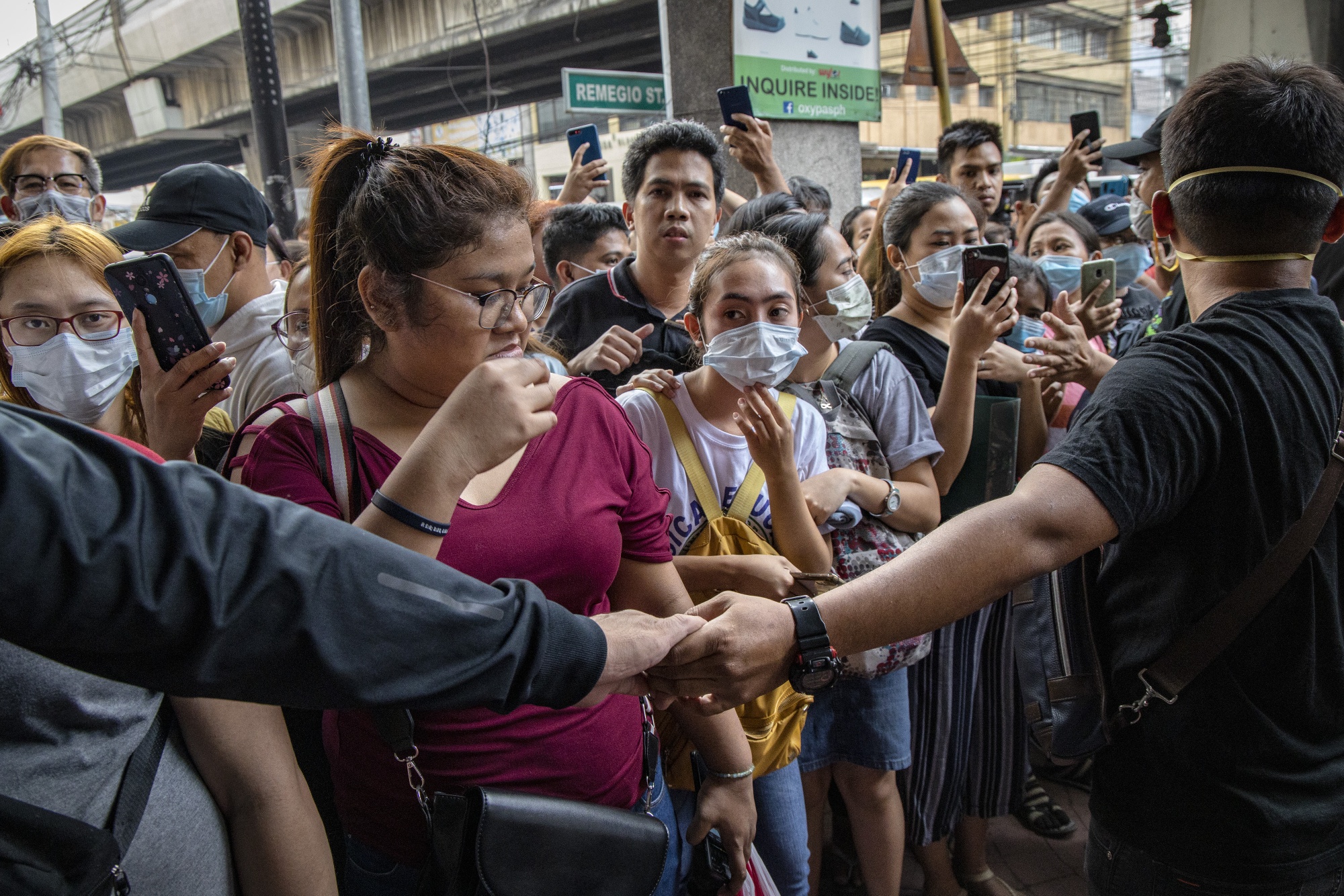 People wait outside a store to purchase protective masks in Manila on Jan. 31.