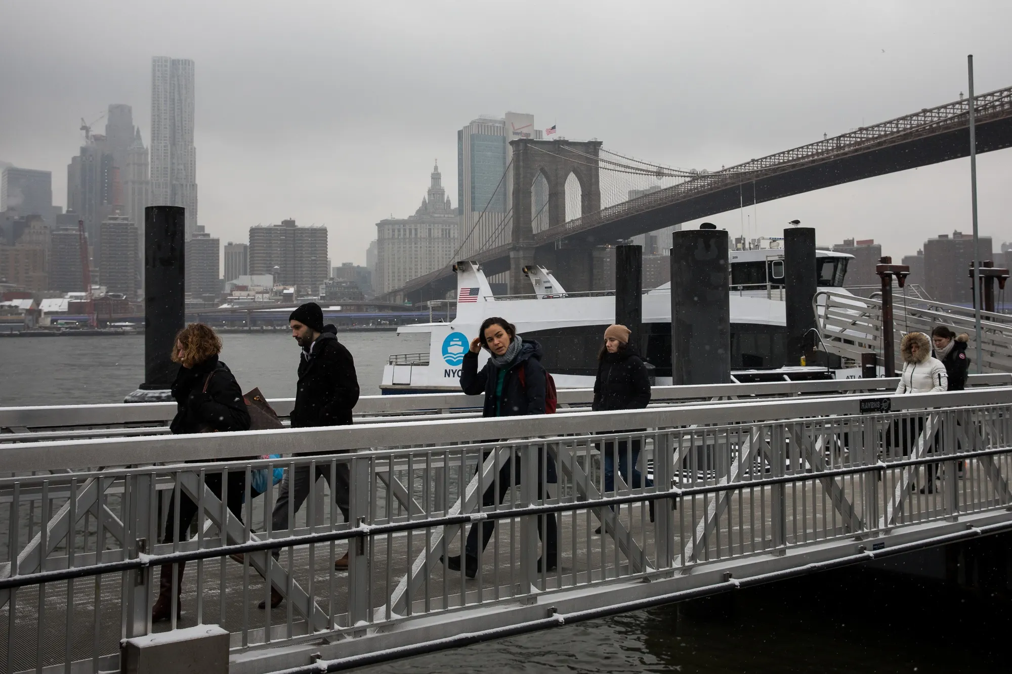 Commuters disembark a NYC Ferry at Brooklyn Bridge Park.