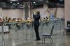 An official poll watcher uses binoculars as workers count ballots for the 2020 Presidential election at the Philadelphia Convention Center in Philadelphia, Pennsylvania, U.S., on Tuesday, Nov. 3, 2020.