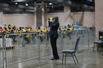 An official poll watcher uses binoculars as workers count ballots for the 2020 Presidential election at the Philadelphia Convention Center in Philadelphia, Pennsylvania, U.S., on Tuesday, Nov. 3, 2020.