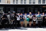 Police disembark from a bus as protesters lock arms to prevent the bus from moving, during a standoff with protesters after the not guilty verdict of Jason Stockley.