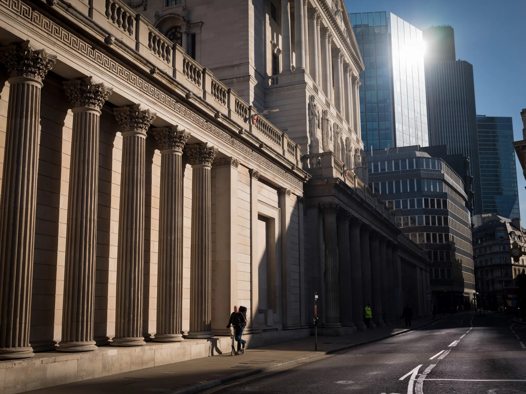 A commuter scoots past the Bank of England in the City of London on March 24.