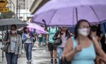 Commuters wear protective masks outside the Luz train station in Sao Paulo, Brazil, on Thursday, Oct. 8, 2020.