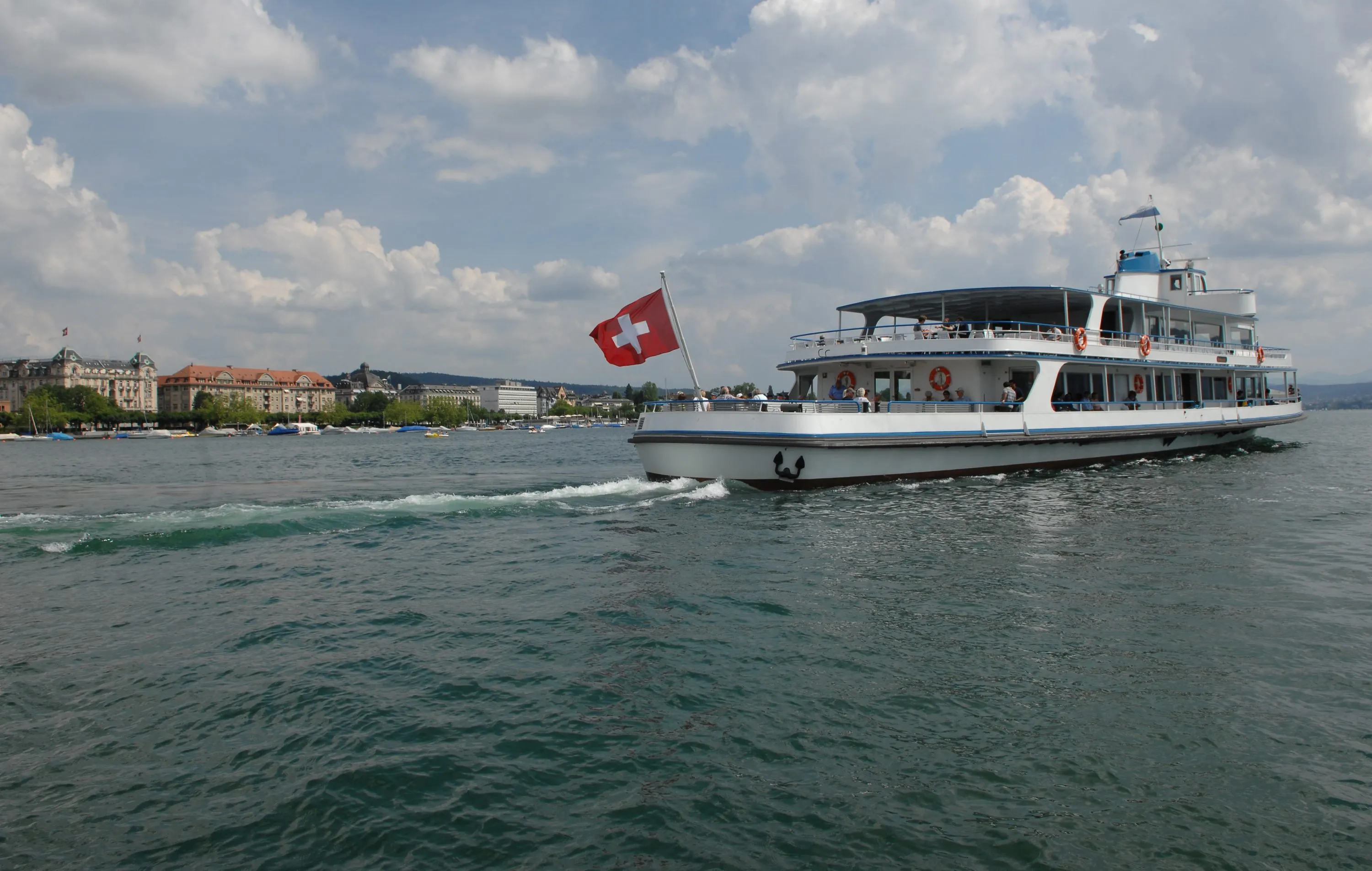 A boat carries tourists on Lake Zurich.