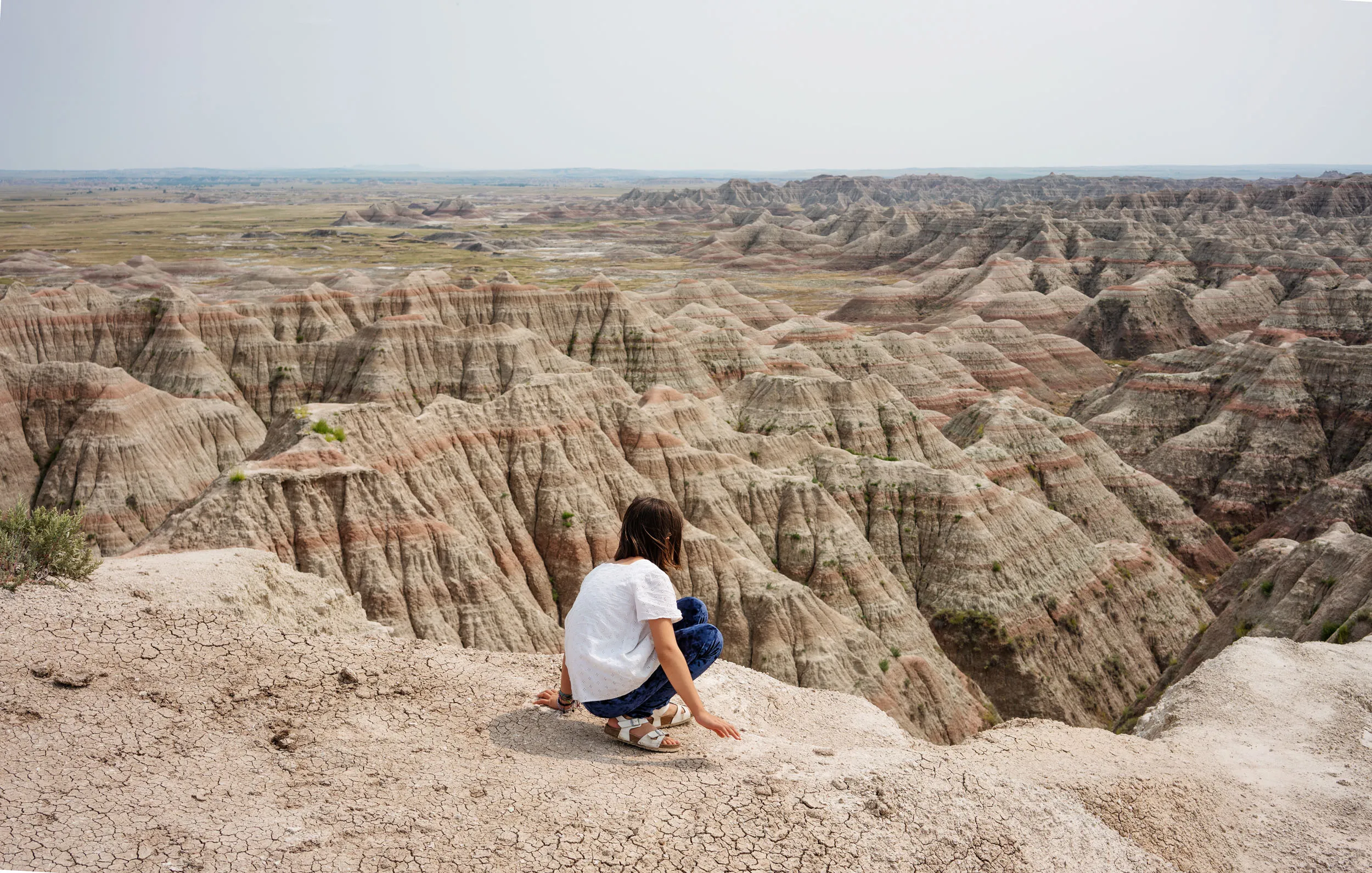 Luella on the precipice at our first stop in the Badlands. She could walk right up to the edge and take in the expansiveness without the intervention of a fence or hovering parents.