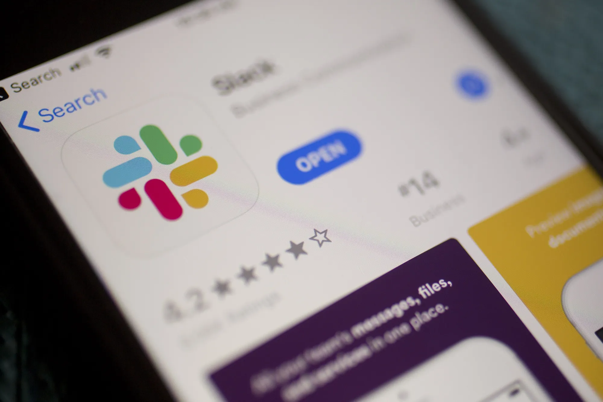 The Slack Technologies Inc. application is displayed in the App Store on an Apple Inc. iPhone in an arranged photograph taken in Arlington, Virginia, U.S. on Monday, April 29, 2019. Slack's filing last week confirms its plans to avoid a traditional public offering and instead list its shares directly on the New York Stock Exchange under the symbol SK.