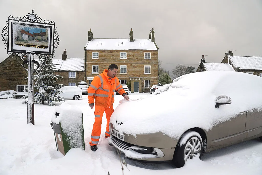A man clears snow from his car in Lythe , North Yorkshire, Jan 3.