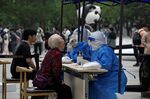 An elderly woman has a sample taken to be tested for the Covid-19 coronavirus at a swab collection site in Beijing.