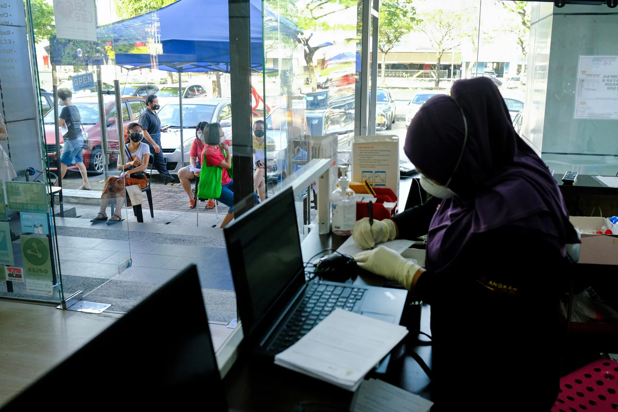 Health workers at the front desk of a Covid-19 testing center&nbsp;in Shah Alam, Selangor, Malaysia.