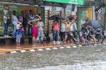Children play as it rains in New Delhi Thursday, June 30, 2025. India's monsoon season runs from June to September. (AP Photo/Rajesh Kumar Singh)
