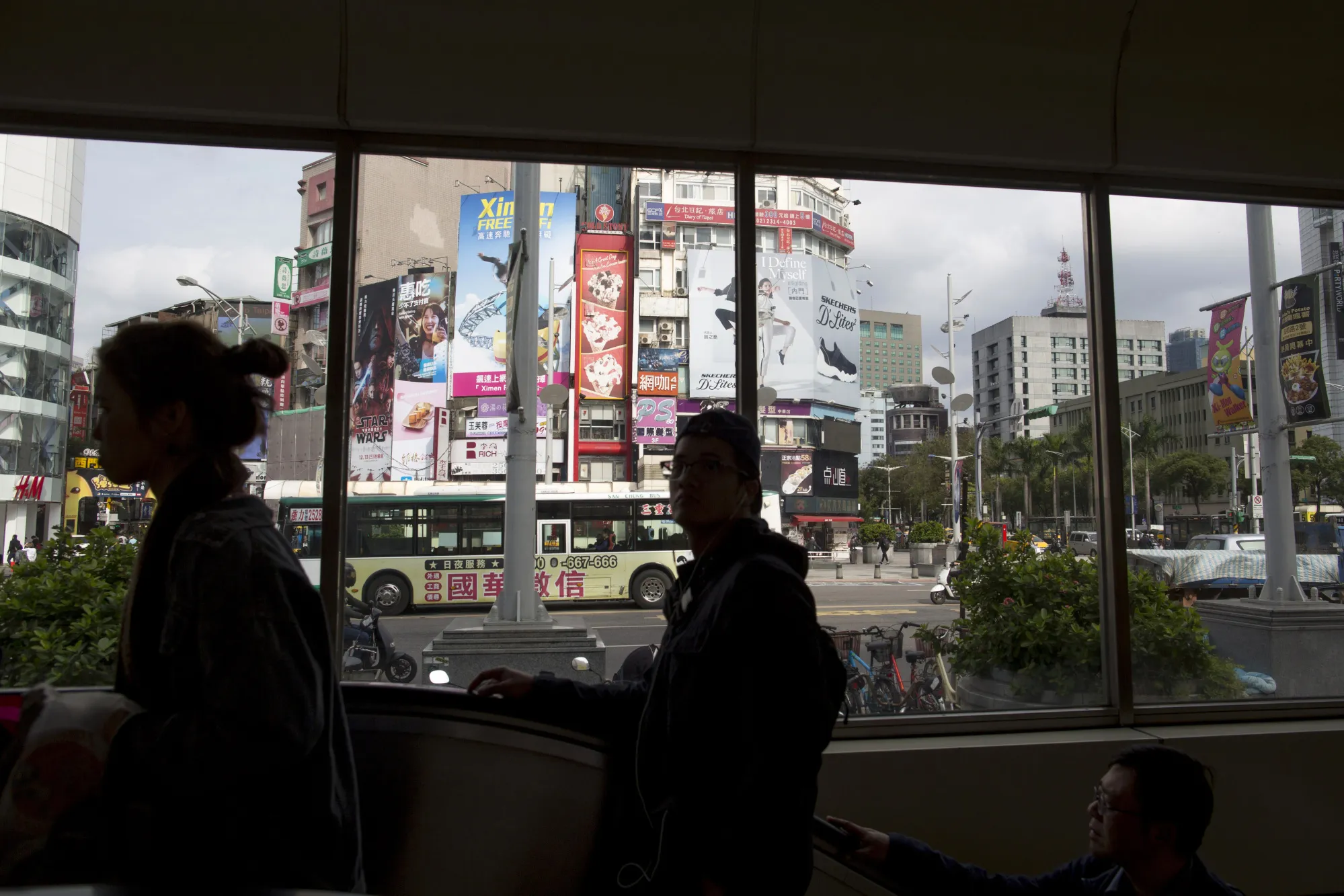 Commuters ride an escalator&nbsp;in the Ximending area of Taipei, Taiwan.