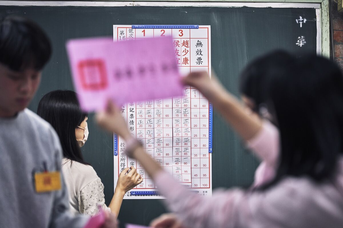 Election workers tally ballots at a polling station in Taipei.