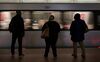 Commuters watch a train arrive at the Gallery Place-Chinatown station.