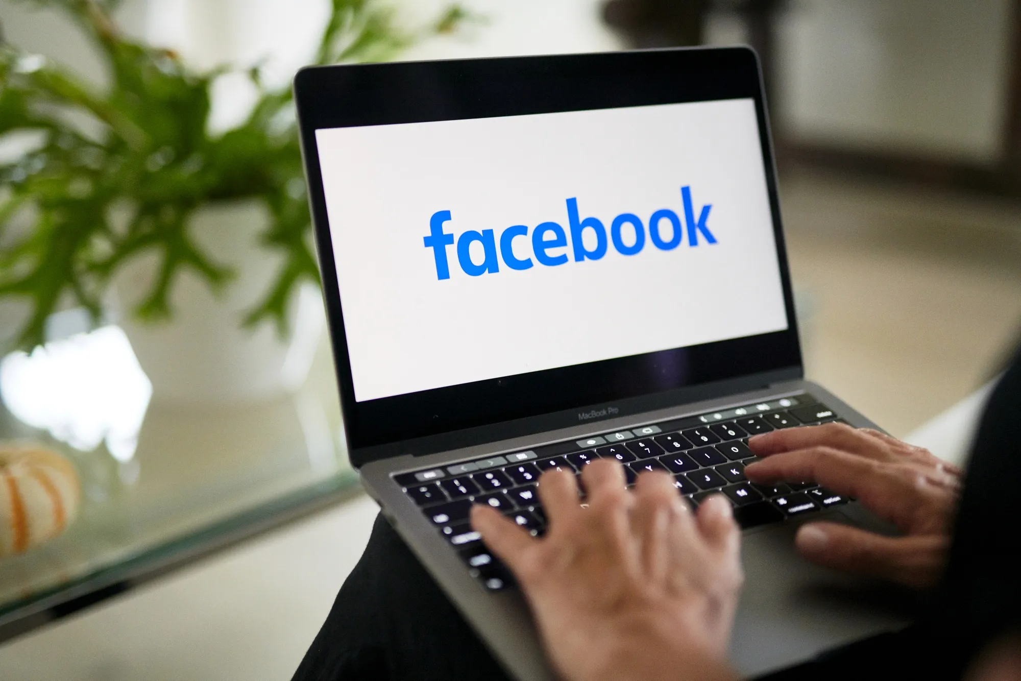 The logo for Facebook on a laptop compute.