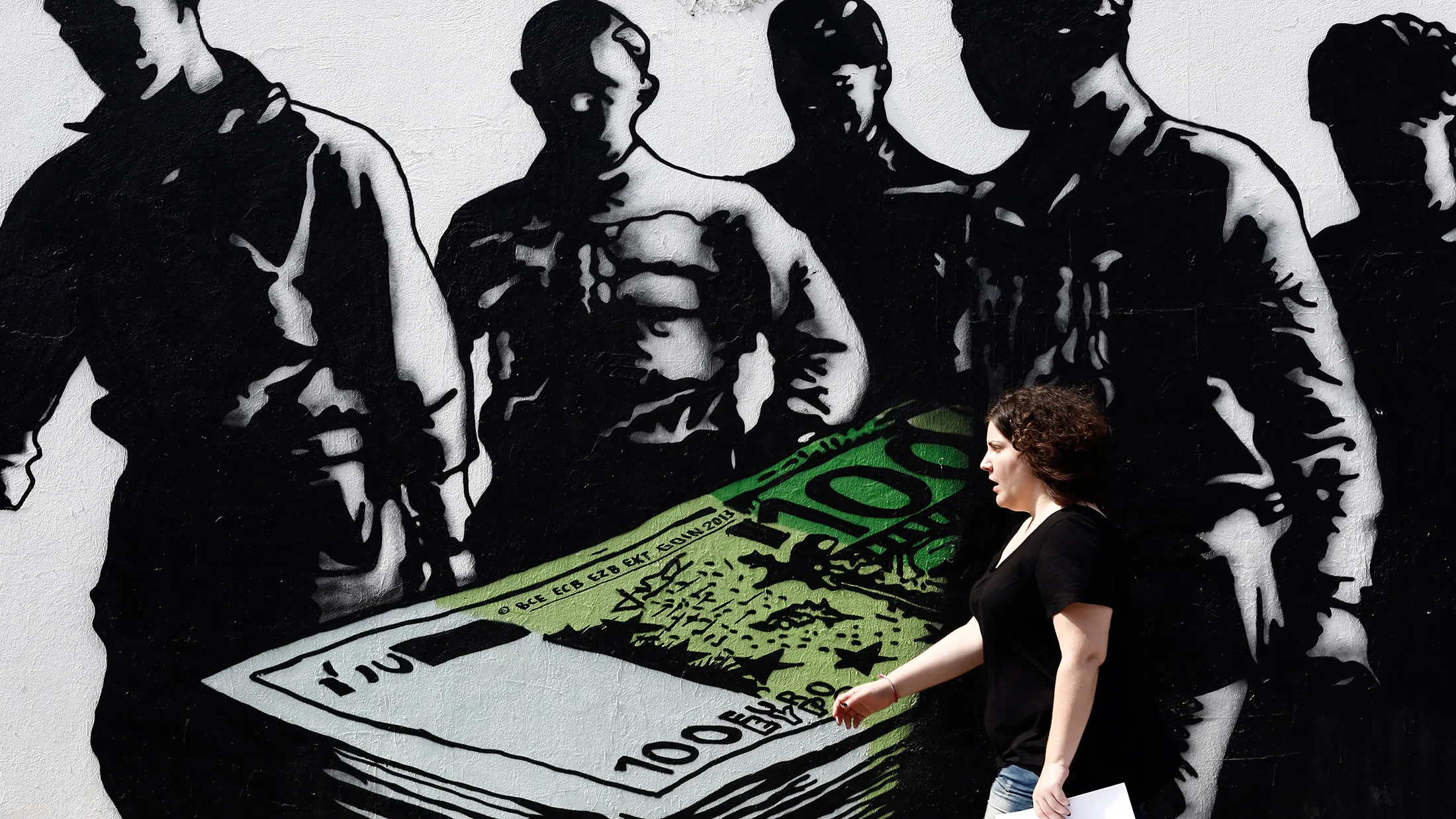Artwork titled "Death of euros," painted by French street artist Goin, on a wall in Athens on May 28, 2015.
