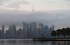 HOBOKEN, NJ - AUG 17: One World Trade Center rises above low clouds as they pass through lower Manhattan at sunrise in New York City on August 17, 2019, as seen from Hoboken, New Jersey. (Photo by Gary Hershorn/Getty Images)